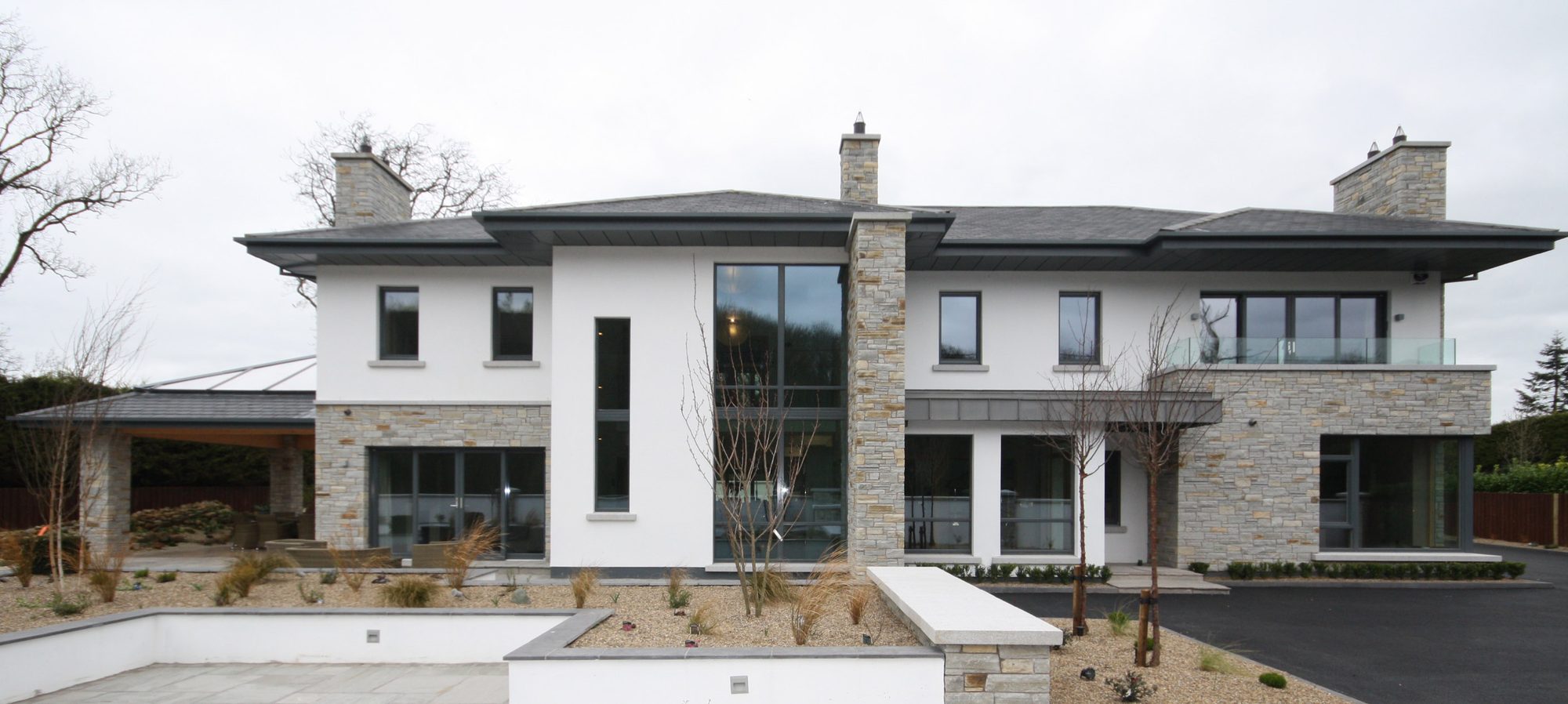 Front elevation of Clones Road House, a south-facing home in stone and render